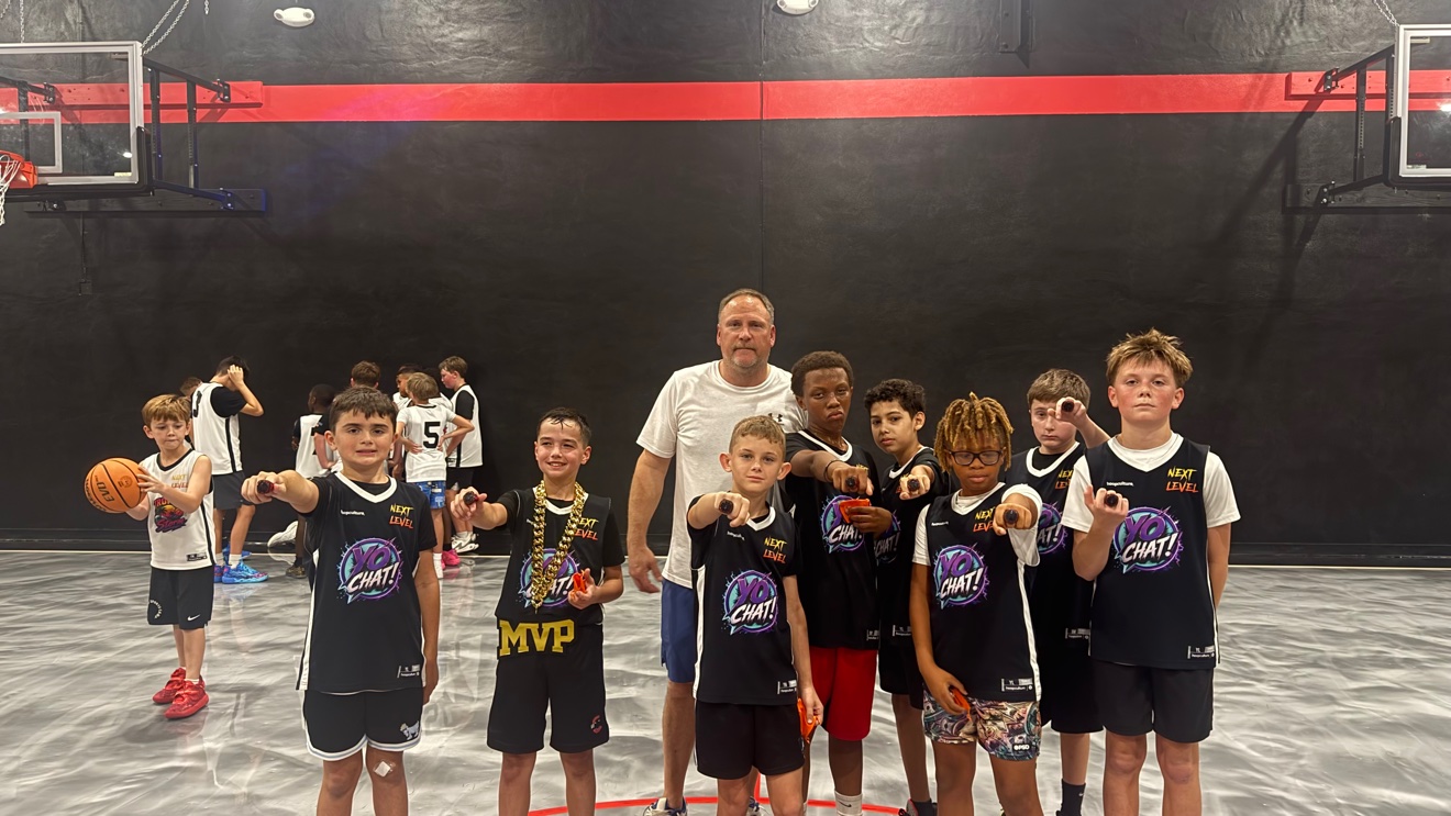 Ascend champions Yo Chat showing their championship rings with their coach