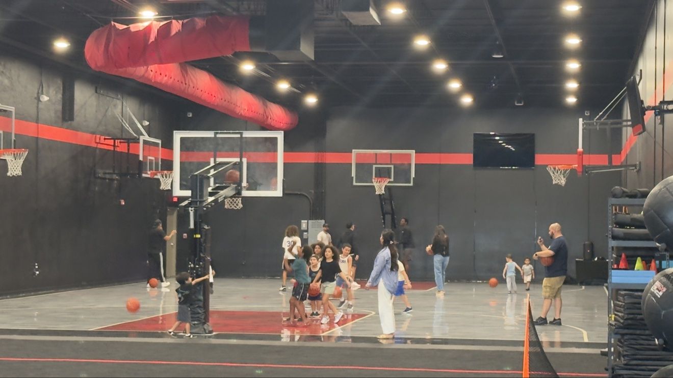 Kids playing basketball on the Next Level court during a birthday party