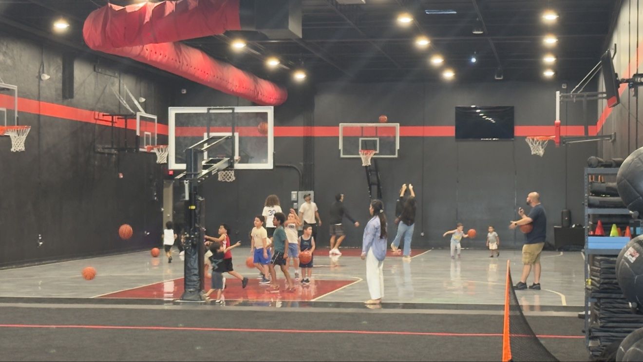 Birthday party guests shooting around on the Next Level court