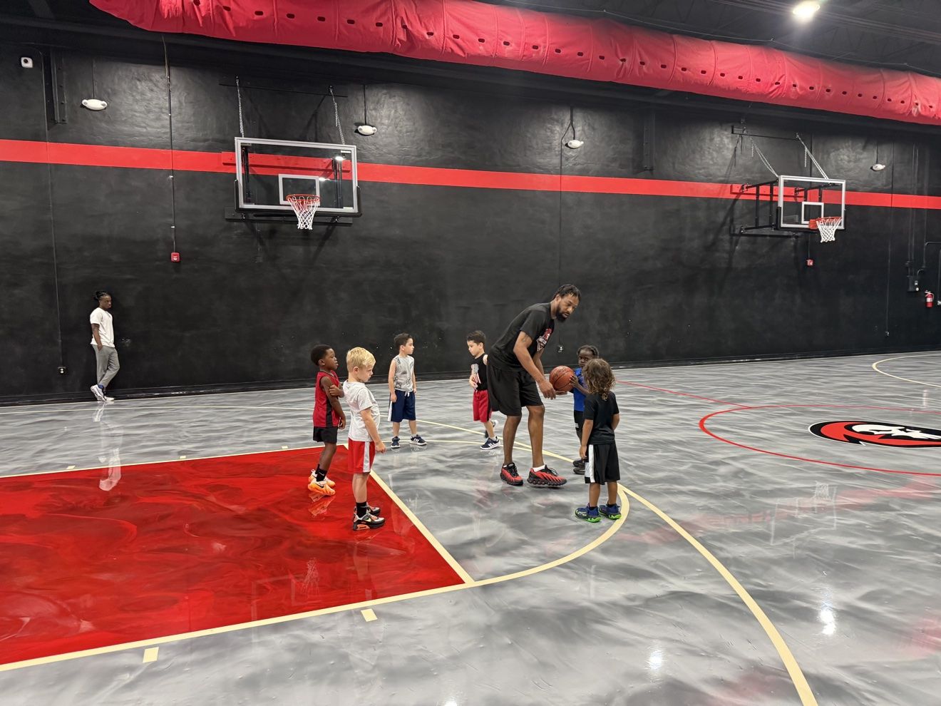 A Next Level coach working with young athletes at the free throw line