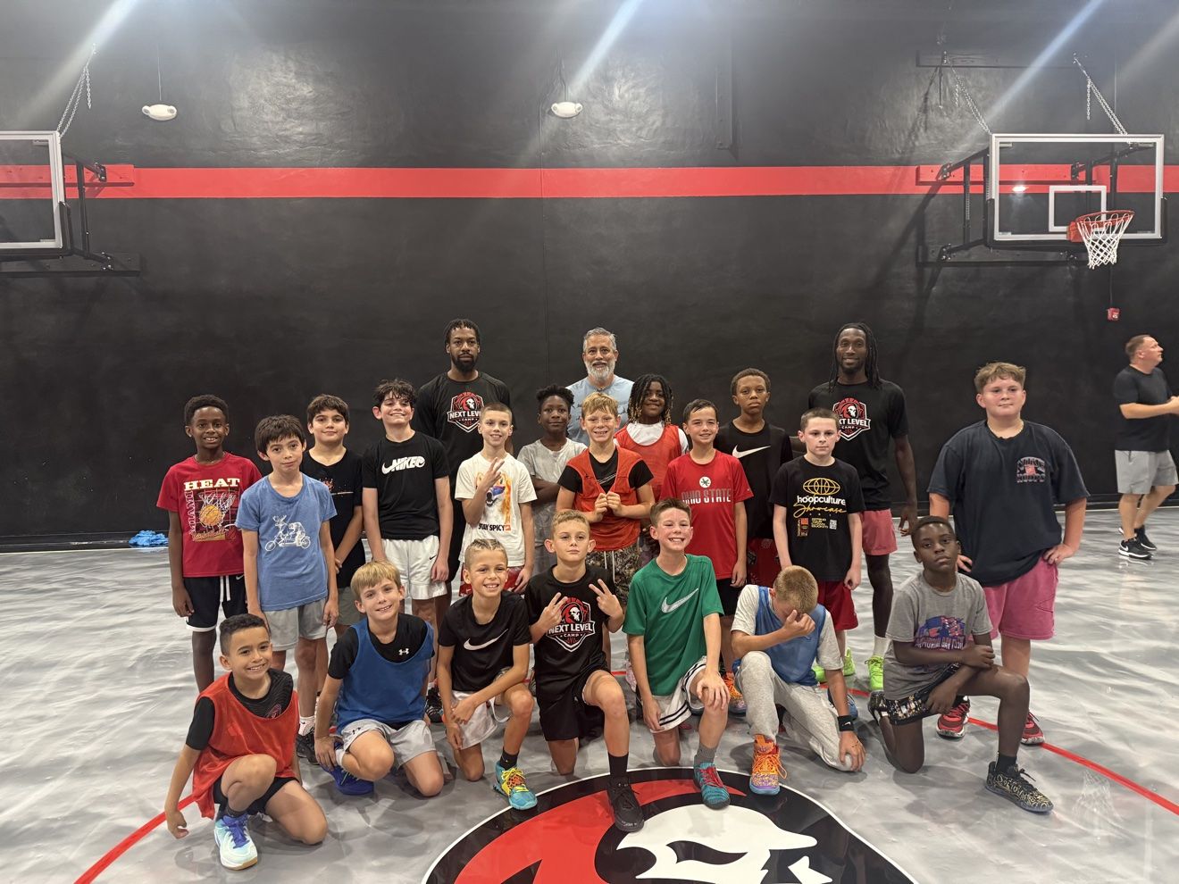 A full development group with their coaches at center court