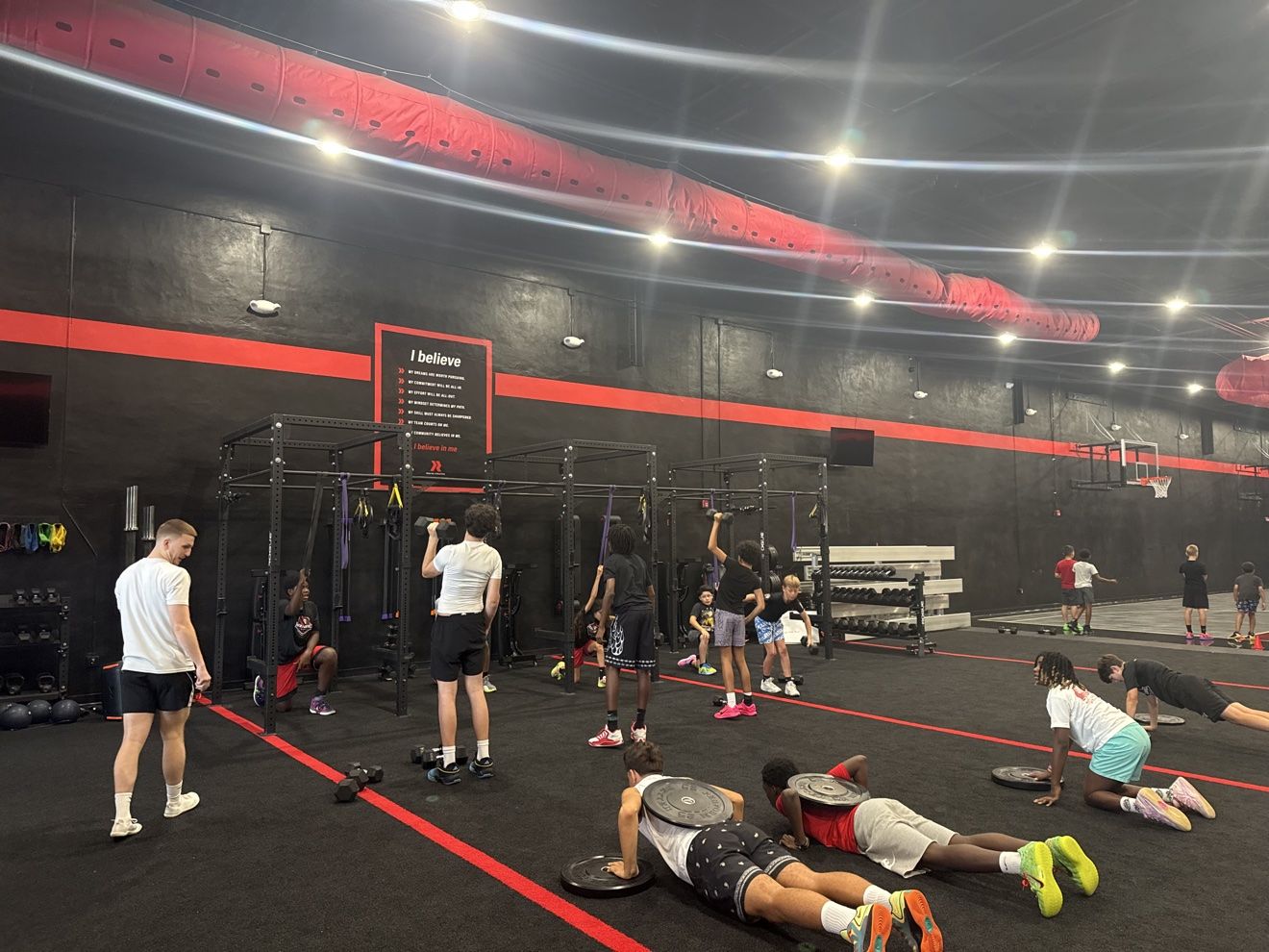 Athletes working through a strength circuit in the Next Level weight room