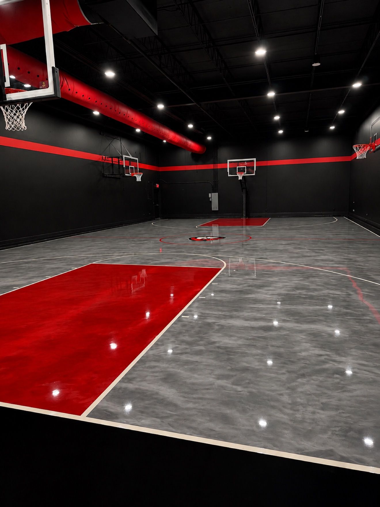 The full Next Level court with its red painted key and center court logo