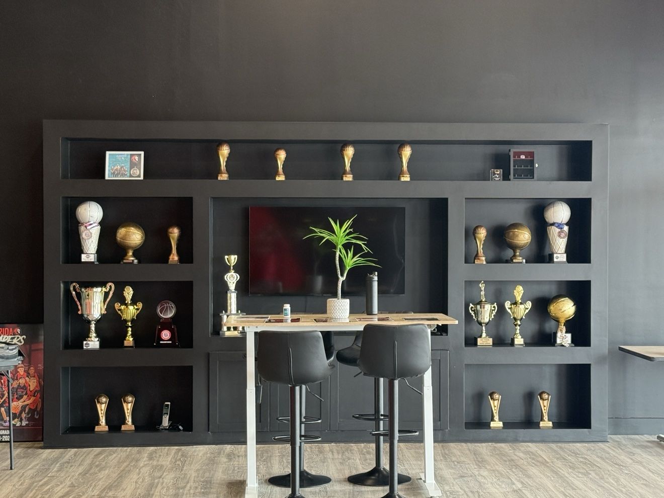 The Next Level front desk and trophy shelves in the lobby